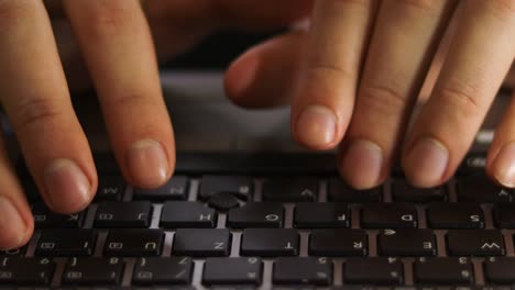 close up of male hands typing on notebook keyboard front view.