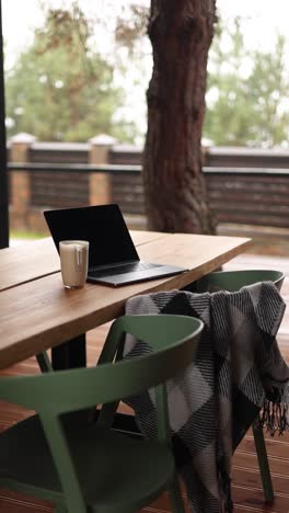 espacio de trabajo al aire libre con portátil y café