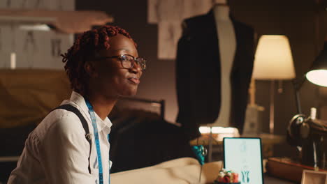 african american tailor using fabric