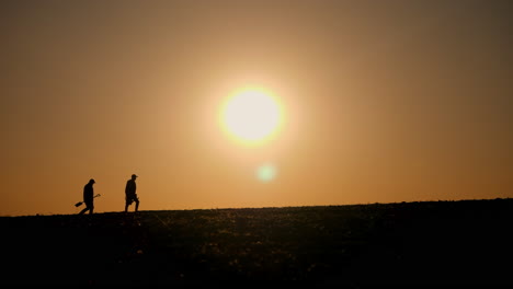 silhouette of farmers at sunset