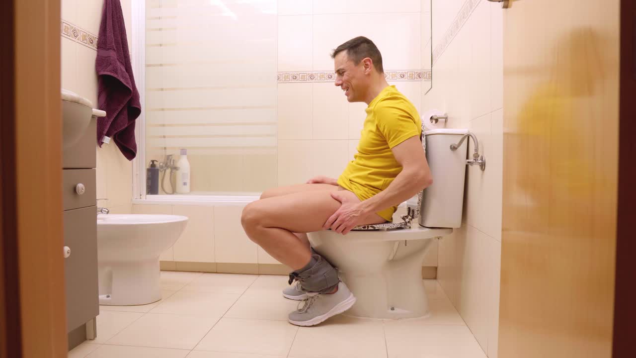 Man relieved after using toilet in bathroom