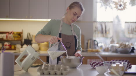 woman preparing meal in kitchen preparing baked goods working