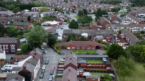 aerial view orbit right above british neighbourhood small town residential suburban property gardens and town streets