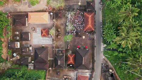 drone footage zooming in on a balinese temple, surrounded by tropical forest in ubud, bali, during a vibrant ceremonial celebration. capturing the essence of bali’s spiritual culture and beauty.
