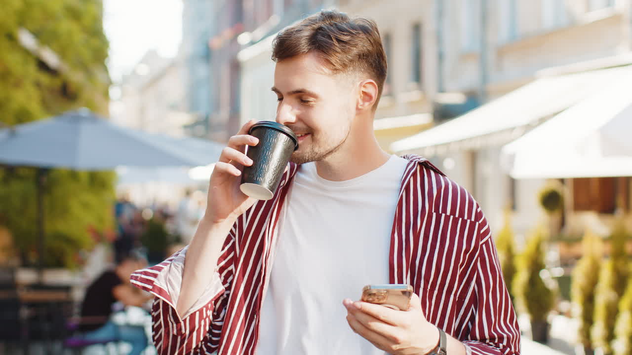 Handsome man guy enjoying drinking morning coffee hot drink relaxing taking a break in city street