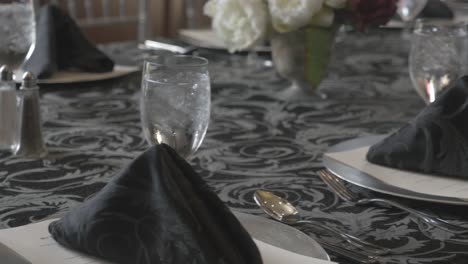 wine glasses filled with iced water on a fancy table.
