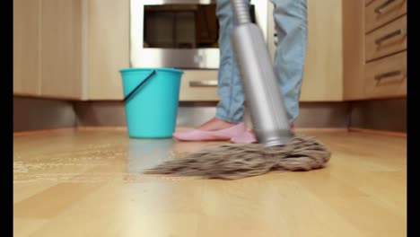 Woman-cleaning-her-kitchen-floor