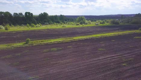 aerial view of a plowed field and rural landscape