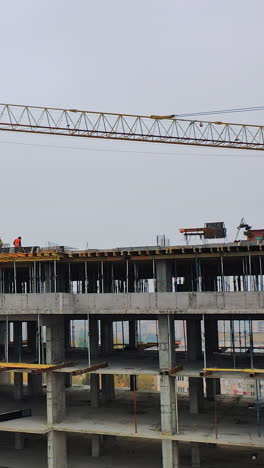 construction site in a megacity. video shooting with drone. new house in a residential complex. motion camera back. vertical video