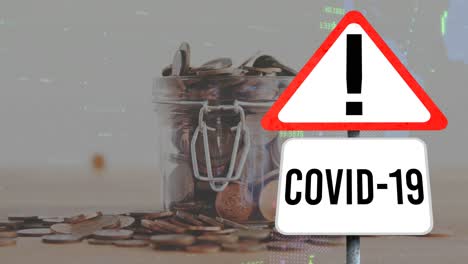 Animation-of-covid-10-warning-sign,-financial-statistics-and-coins-falling-in-jar