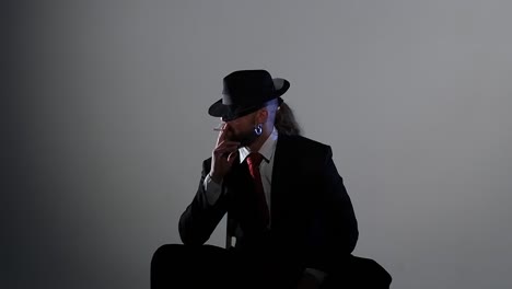 man in a suit smoking a cigar