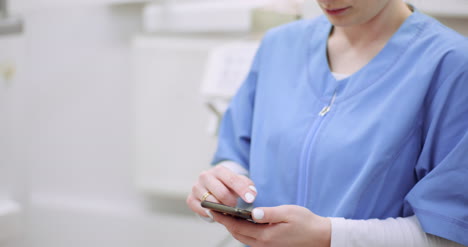 female doctor using mobile at healthcare clinic 2