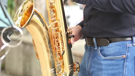 close-up of a man playing a gold saxophone