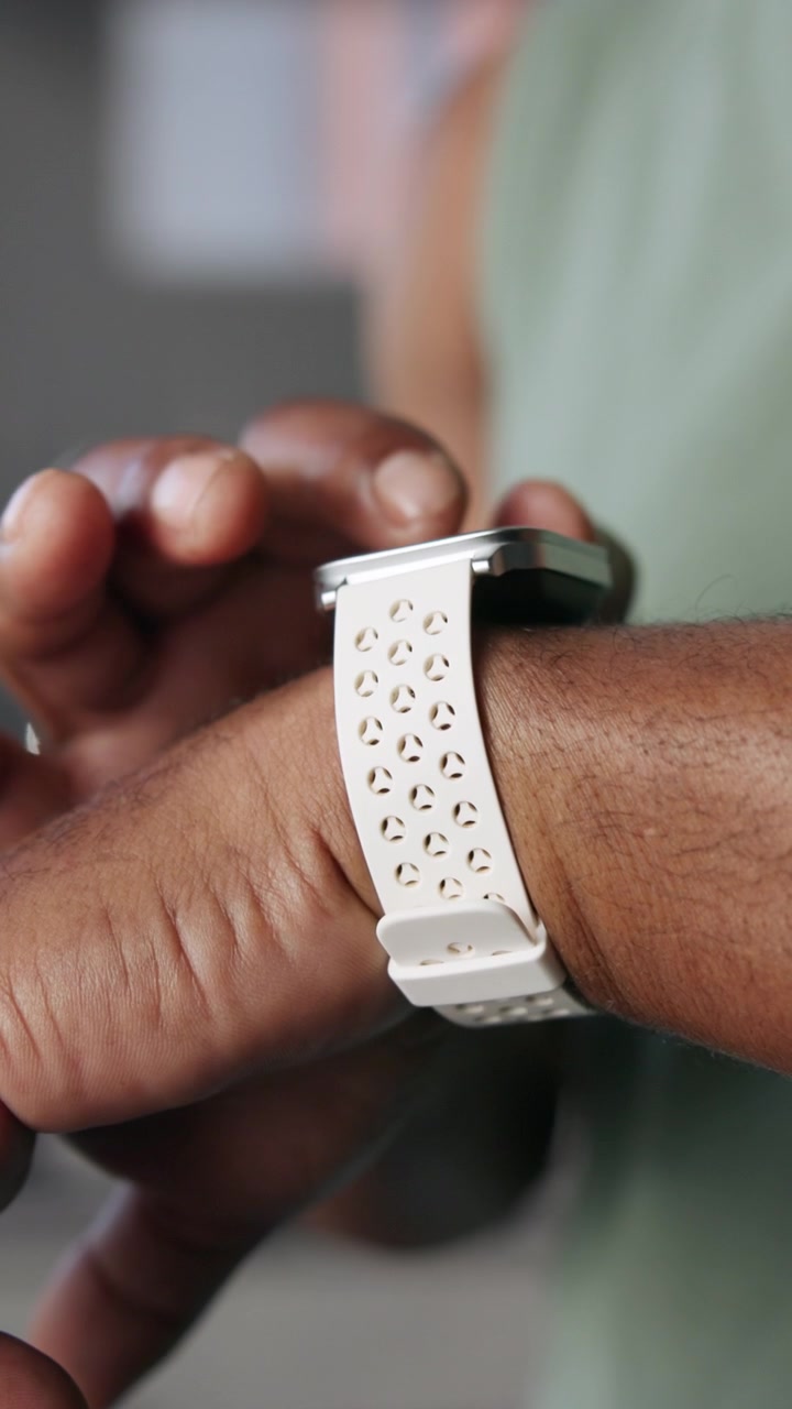 Person Using Smartwatch with Perforated Silicone Band