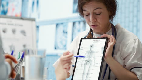 healthcare provider presenting lab test results to a patient in cabinet