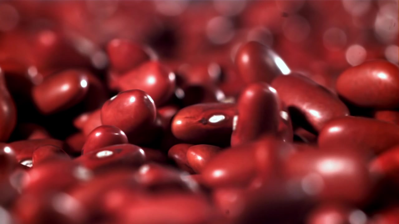 Close-up of Red Kidney Beans Falling and Bouncing in Slow Motion