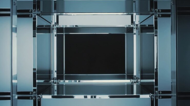 Playback starting, camera moving toward central metal-glass cube in studio, revealing black void
