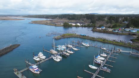 Beautiful-4K-aerial-drone-shot-peaking-over-Old-Town-Bandon-and-docked-boats-in-Southern-Oregon