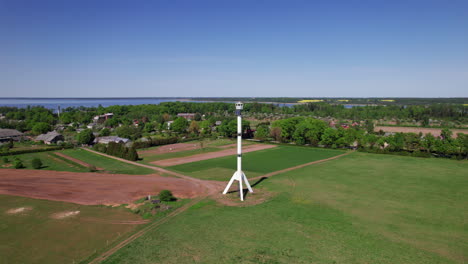 orbital shot of watchtower shaped like a rocket in burtnieku, latvia