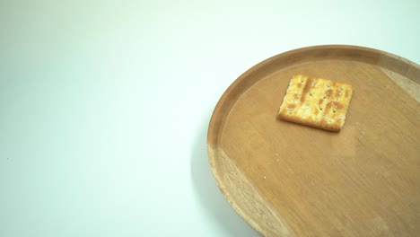 christmas cracker biscuit over the wooden plate, fork and spoon with white background.