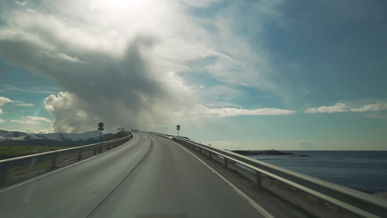 A drive on the famous Atlantic Road in Norway. View from the car. Camera following all the curves and arches of the road, as it is leading through the archipelago