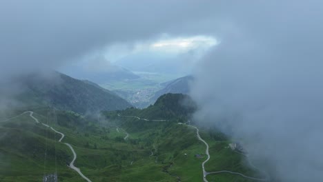 Fog-parts-to-reveal-a-beautiful-extended-green-meadow-below