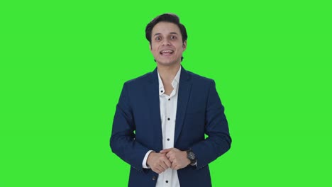 Happy-Indian-manager-talking-to-someone-Green-screen