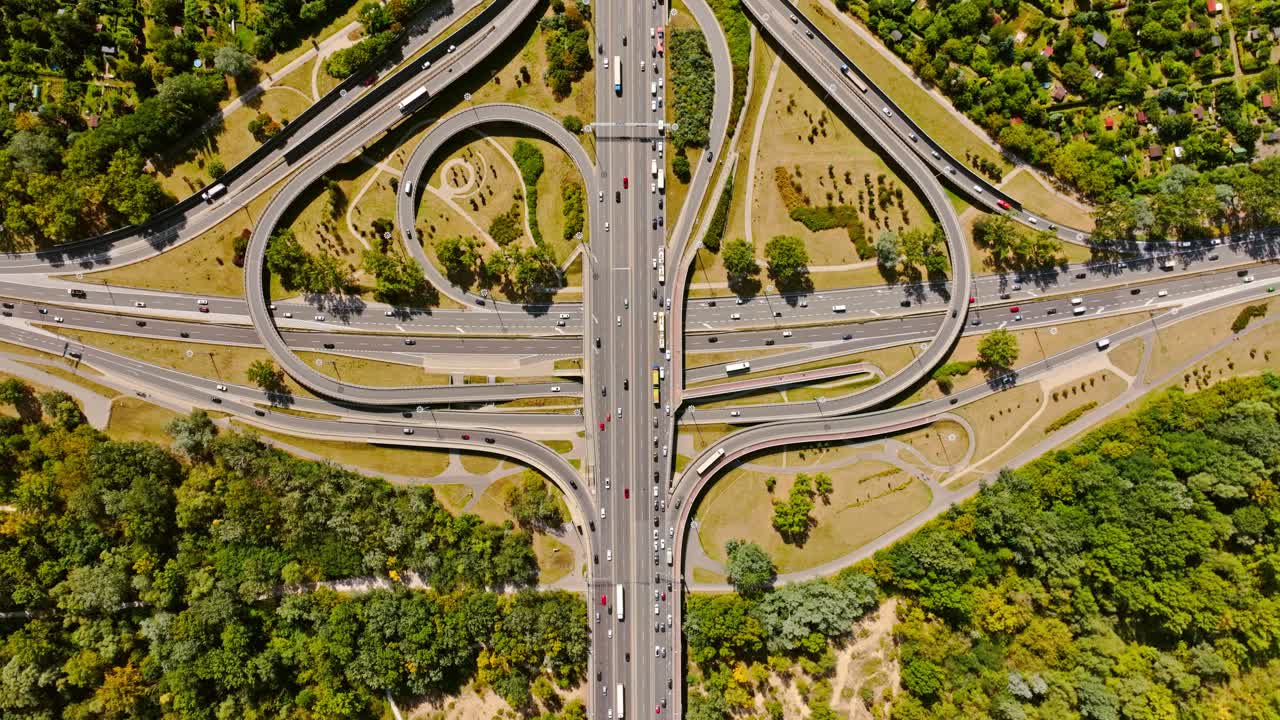 Top down drone shot shows urban traffic flow across Warsaw road system