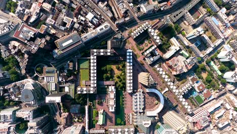 Vertical-aerial-view-from-the-Barbican,-Finsbury-Circus-Gardens-to-City-of-London-towers