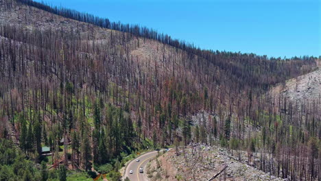 Traffic-passing-through-Eldorado-National-Forest,-severe-wildfire-damage