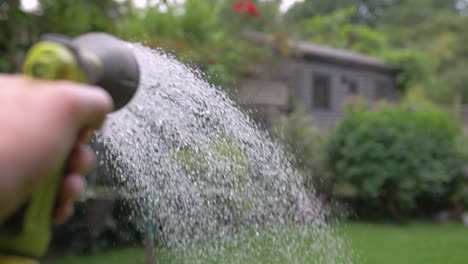 Garden hose watering a garden in slow motion-1