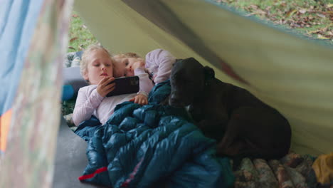 camp, phone and children in a tent outdoor