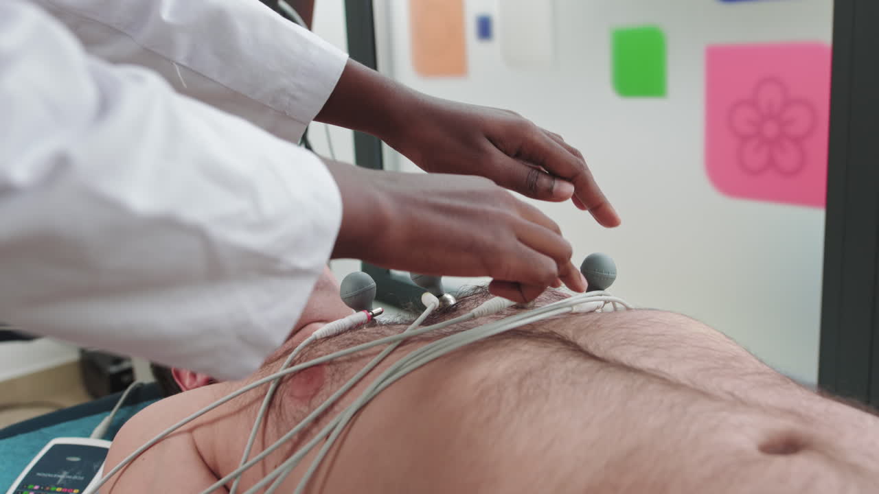 Doctor cardiologist preparing to cardiogram heart procedure side view woman cardiologist making