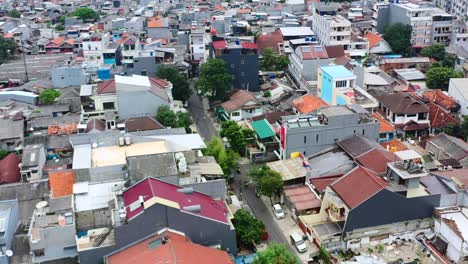 aerial top down of motorbikes driving down residential streets in jakarta indonesia