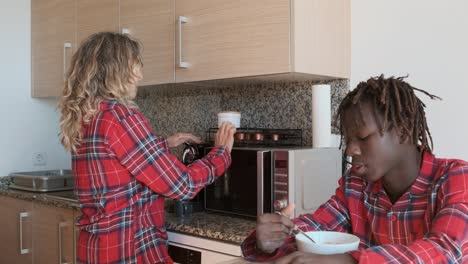 people in the kitchen having breakfast