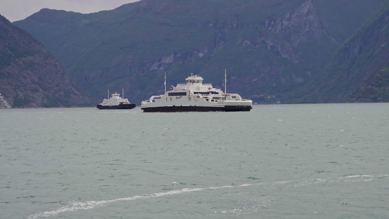 Epic mountain biking adventure above the fjords near Sogndal, Norway. Rider tackles rugged trails surrounded by dramatic cliffs, lush green hills, and stunning Nordic scenery