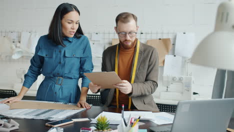fashion designers discussing designs in a studio