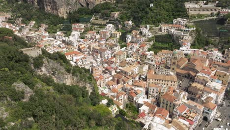 Amalfi-cathedral-and-bustling-town-in-italy,-sunny-day,-aerial-view