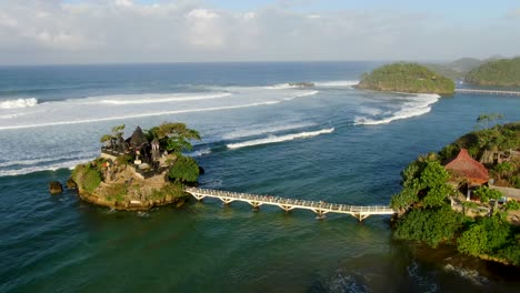 picturesque balekambang hindu temple on rocky island on java coast, aerial view