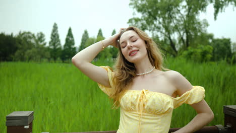 fashionista woman wearing fairy dress and posing in front of camera at the field