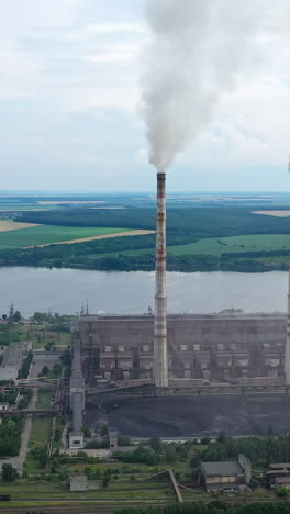 aerial view of big factory territory with huge tubes. industrial architecture factory warehouses. vertical video