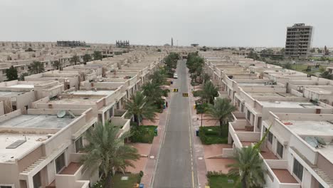 aerial flying over urban road at bahria town housing estate in karachi