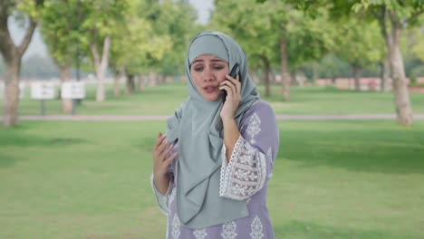 angry muslim woman shouting on phone in park