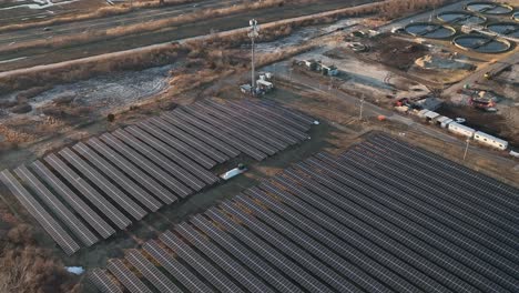 an aerial view of many large solar panels on a sunny day