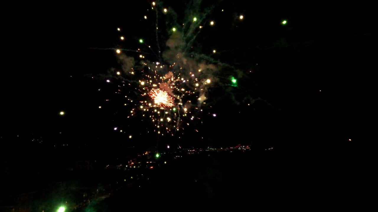Dramatic aerial view of vivid fireworks bursting at night