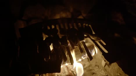 wild foraged mussels slowly cook above an open log fire in an old fireplace
