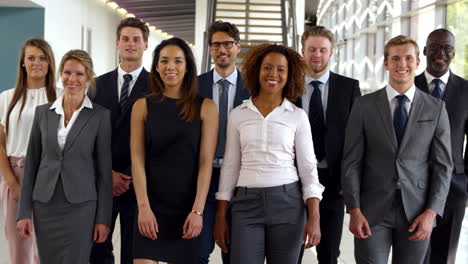 portrait of business team walking towards camera in office