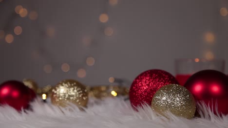 christmas ornaments lying on white fur