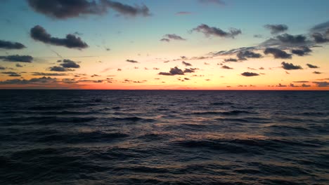 Tropical-golden-sunset-over-ocean-water-slow-motion-aerial-view