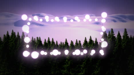 pink glowing decorative fairy lights against winter landscape with trees